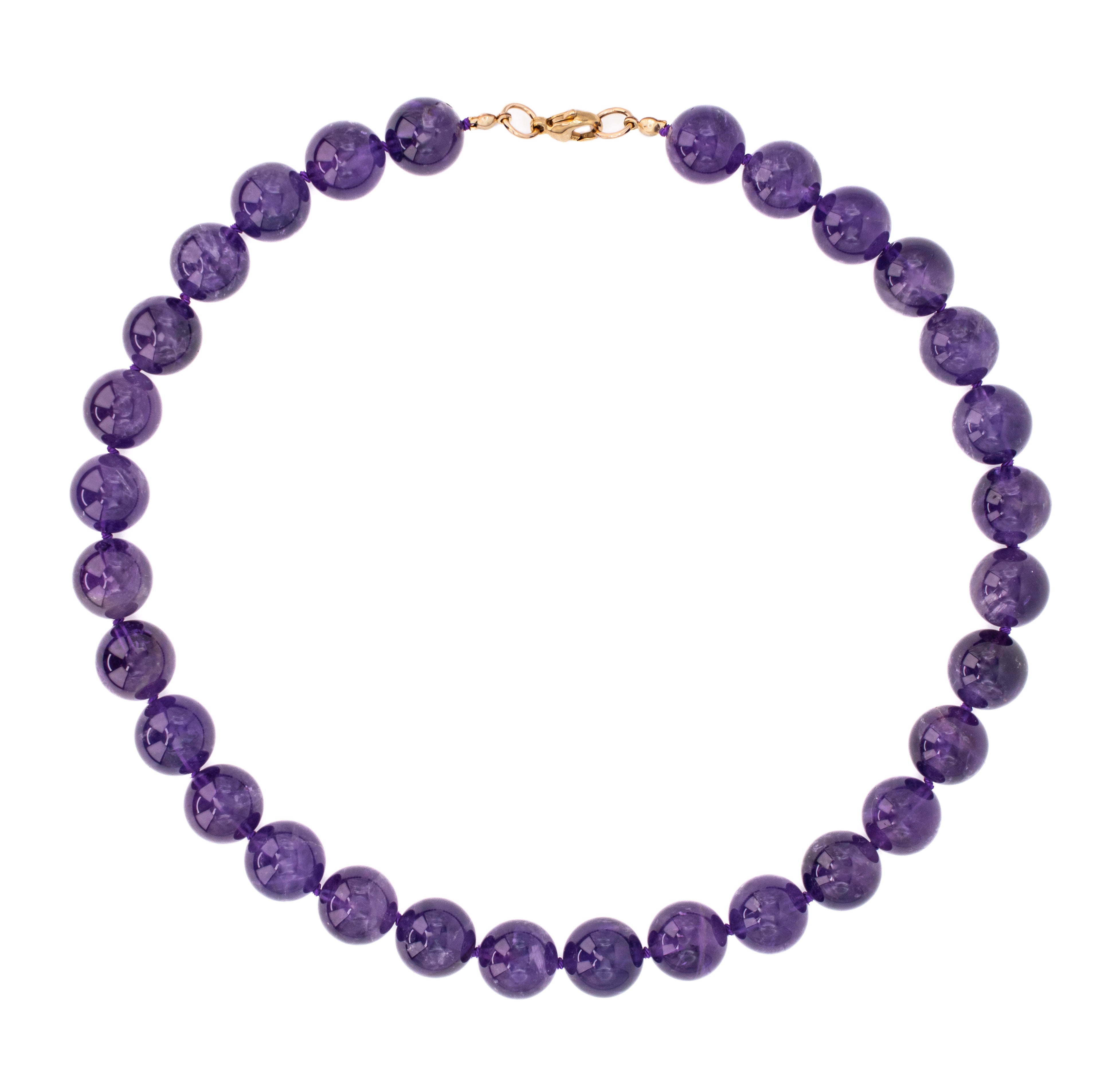 Purple beaded necklace with a gold clasp on a white background