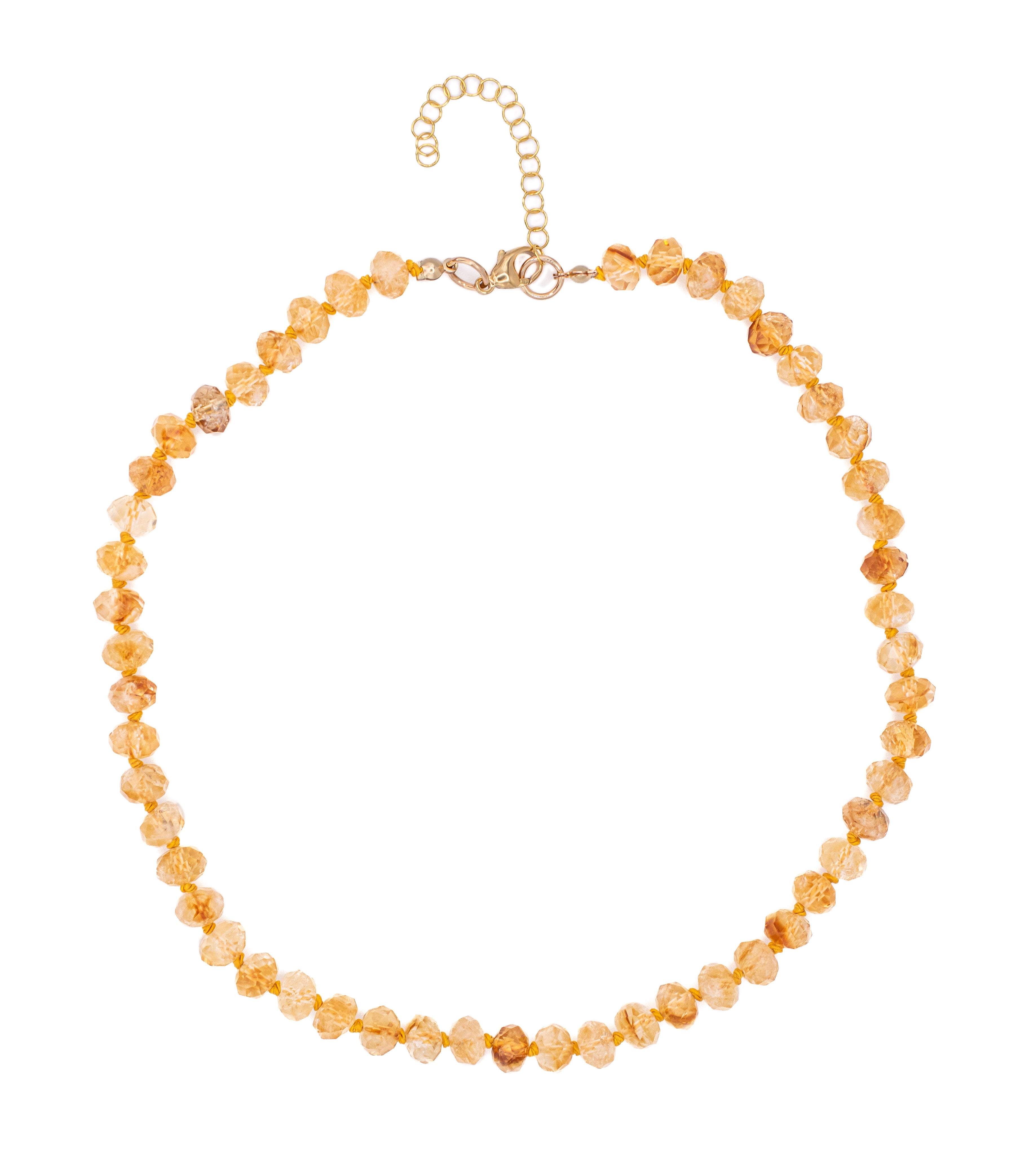 Gold beaded necklace on a white background